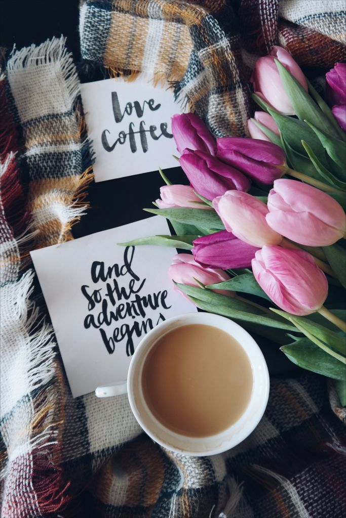 Warm and inviting coffee setup with tulips and calligraphy cards, perfect for cozy mornings.